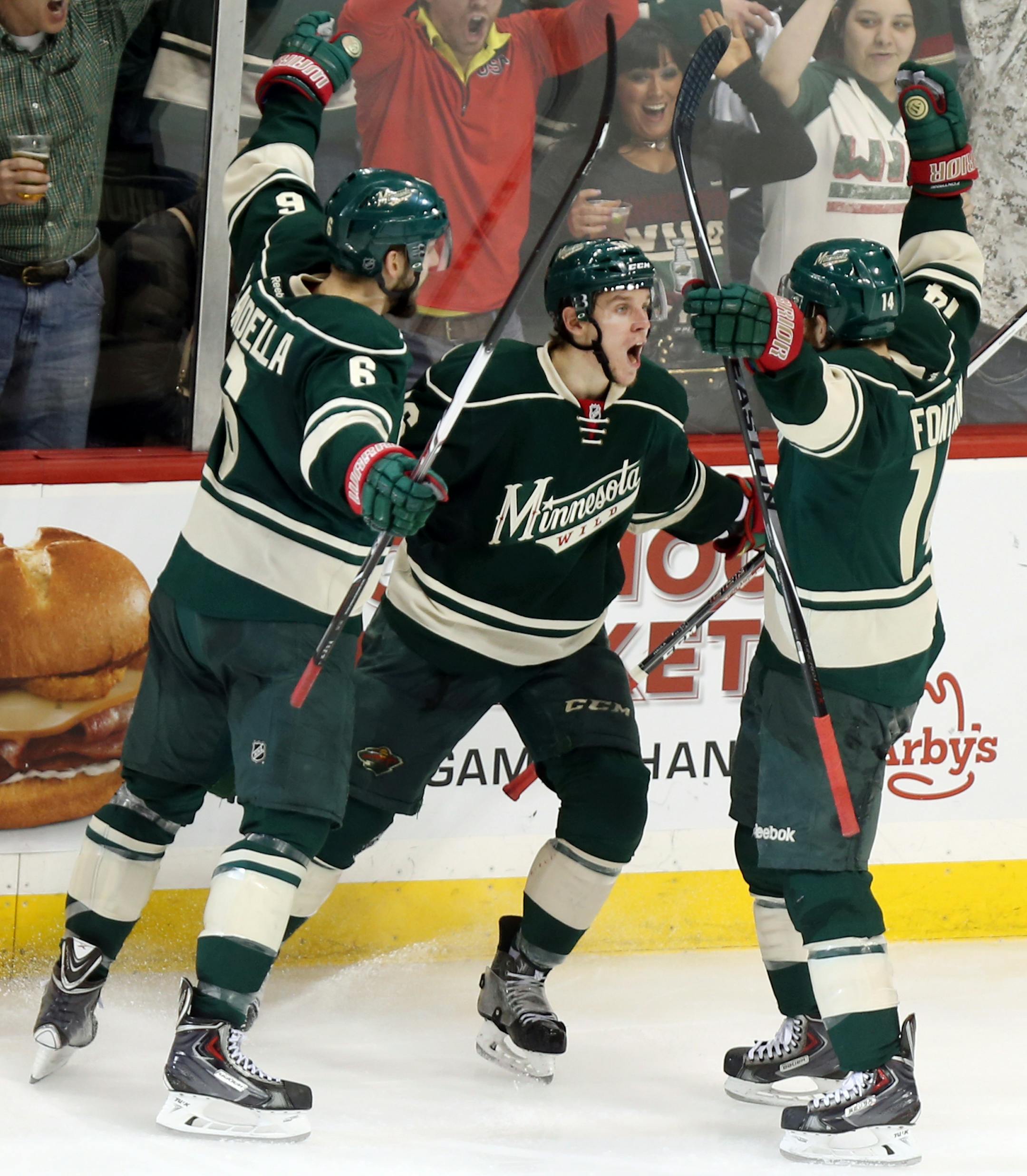 Minnesota Wild left wing Erik Haula (56) (center) celebrated with teammates Minnesota Wild defenseman Marco Scandella (6) (left) and Minnesota Wild right wing Justin Fontaine (14) (right) after scoring in the third period as the Minnesota Wild took on the Chicago Blackhawks in game 3 of the series the the Stanley Cup Playoffs, Tuesday, May 6, 2014 at the Xcel Energy Center in St. Paul, MN. ] (ELIZABETH FLORES/STAR TRIBUNE) ELIZABETH FLORES • eflores@startribune.com
