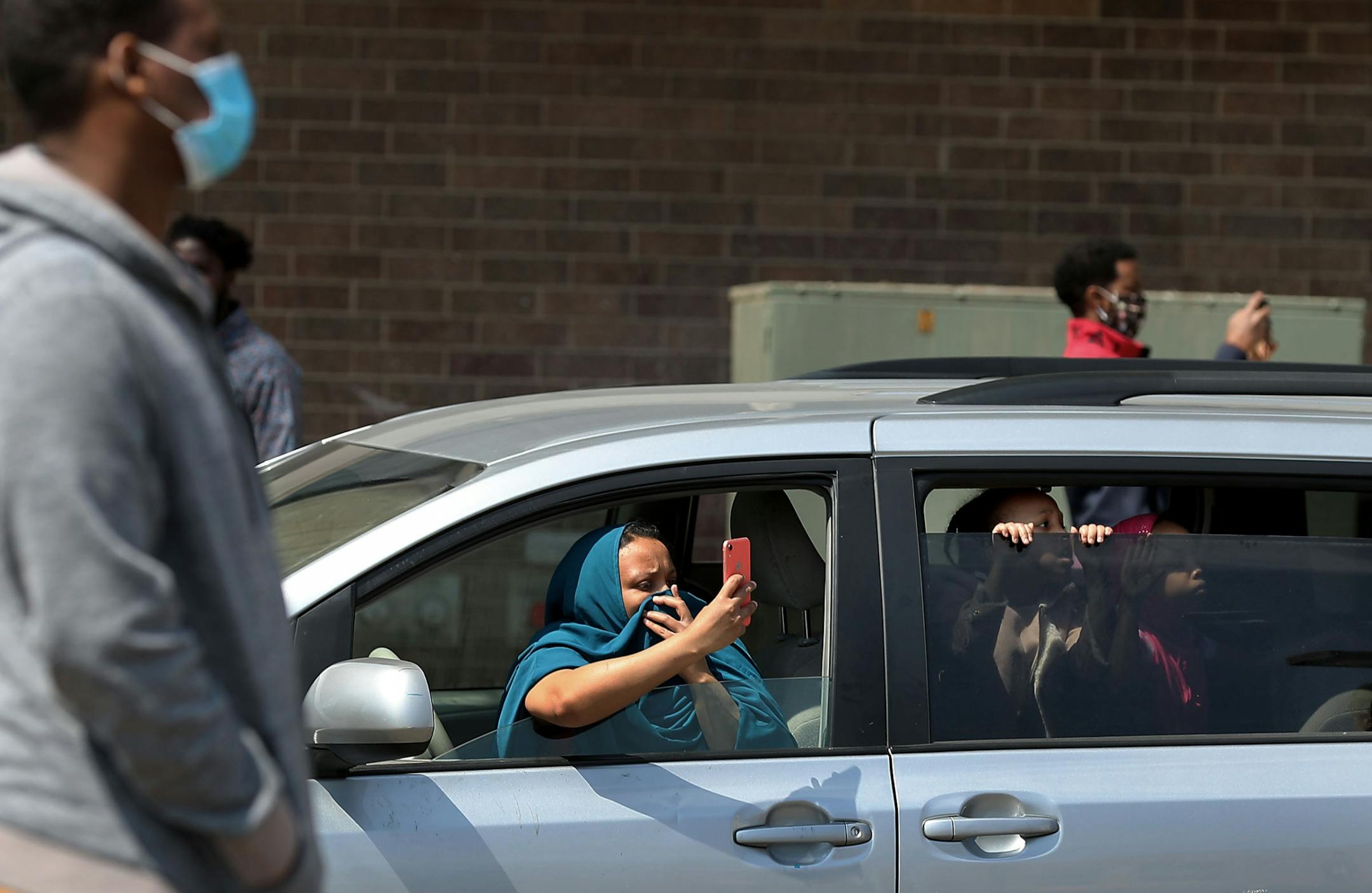 Amal Mohamed of Minneapolis brought her five children with her to witness and hear as Friday afternoon prayers sounded from loudspeakers on the roof of Dar al-Hijrah mosque in the Cedar-Riverside neighborhood Friday, April 24, 2020, in Minneapolis, MN. The Islamic call to prayer echoed for the first time throughout the Minneapolis neighborhood Thursday night and will continue five times a day during Ramadan.