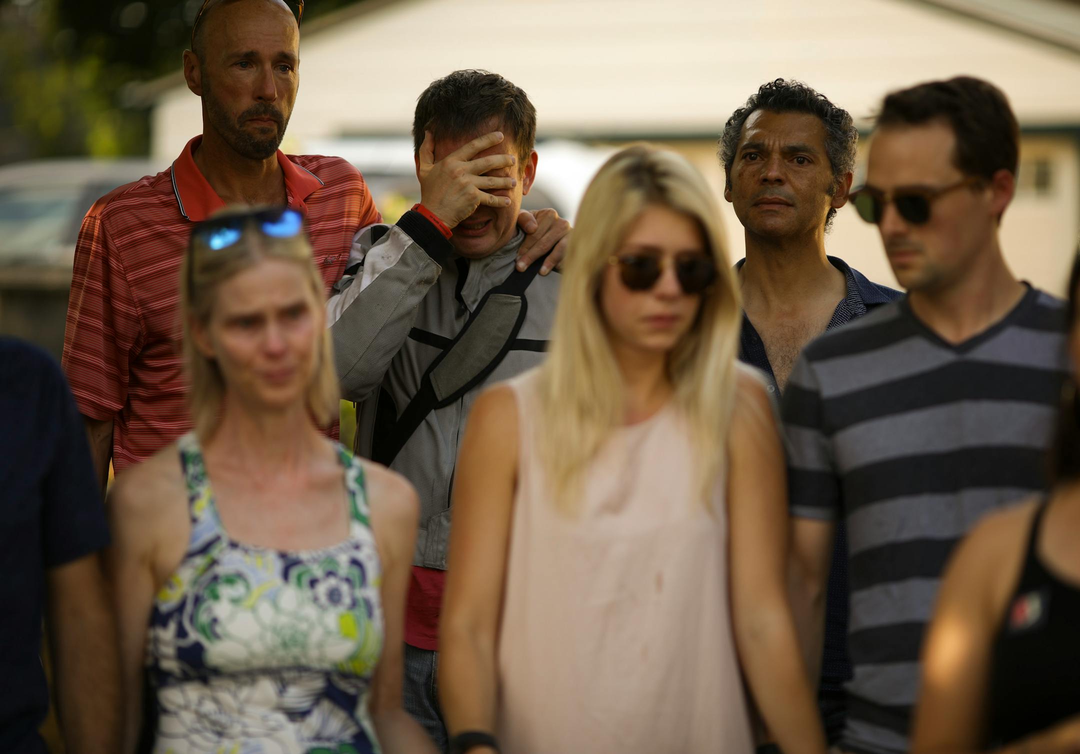 Jay Peterson, left, comforted Corey Birkholz as they listened to a speaker at a vigil to remember Justine Damond on Sunday evening.