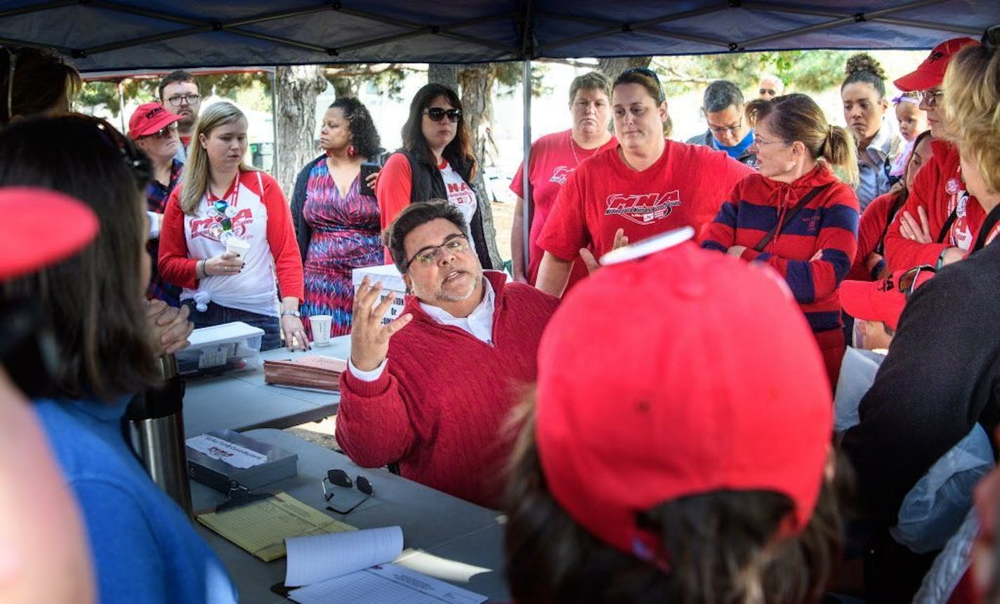 Robert Pandiscio, director of field operations for Minnesota Nurses Association explained the tentative contract to skeptical and sometimes angry union members in a park near Abbott Northwestern Hospital.