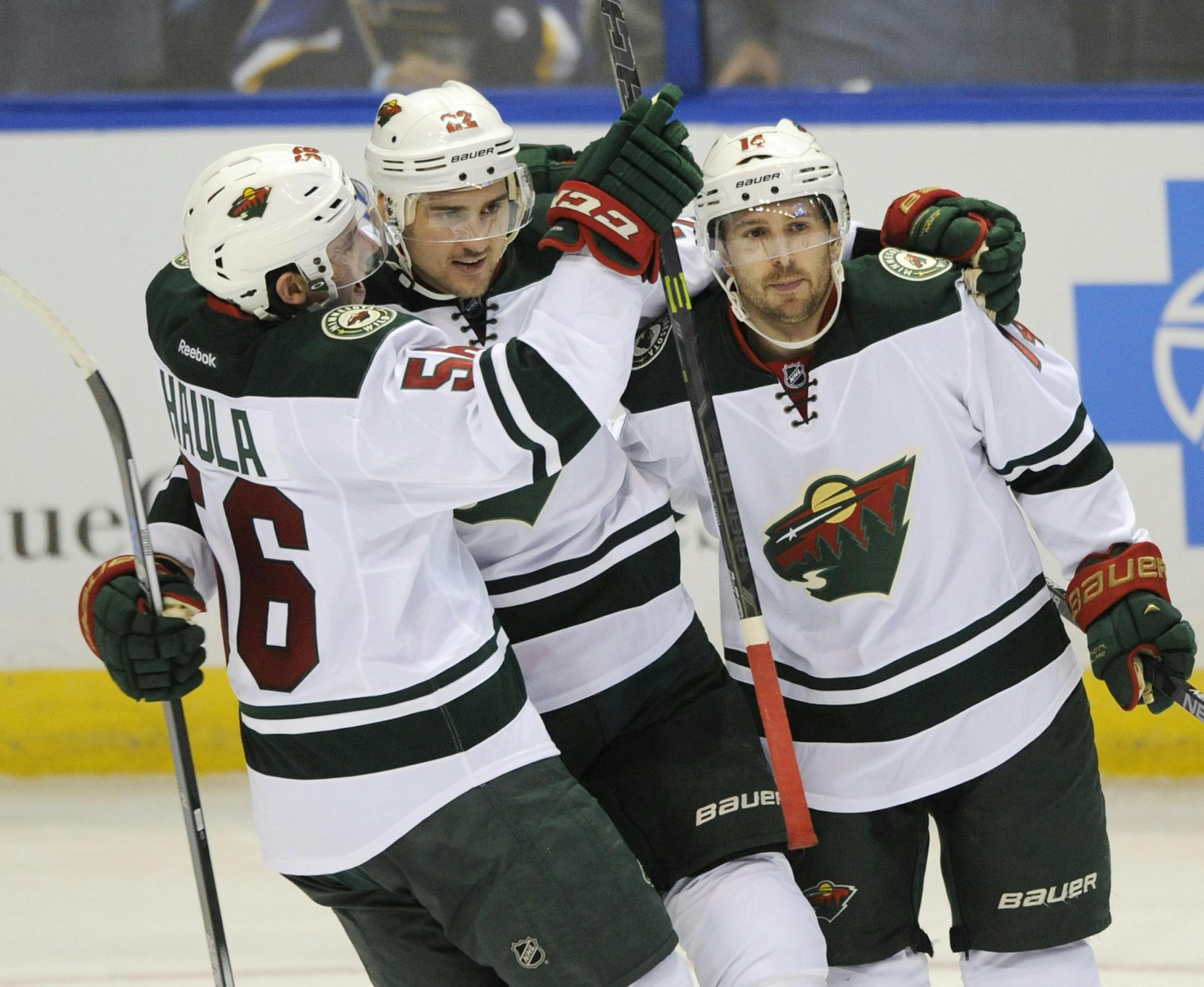Minnesota Wild's Nino Niederreiter (22), of Switzerland, celebrates a goal with Erik Haula (56) and Justin Fontaine (14) against the St. Louis Blues during the second period of an NHL hockey game, Thursday, Dec. 31, 2015, in St. Louis. (AP Photo/Bill Boyce)