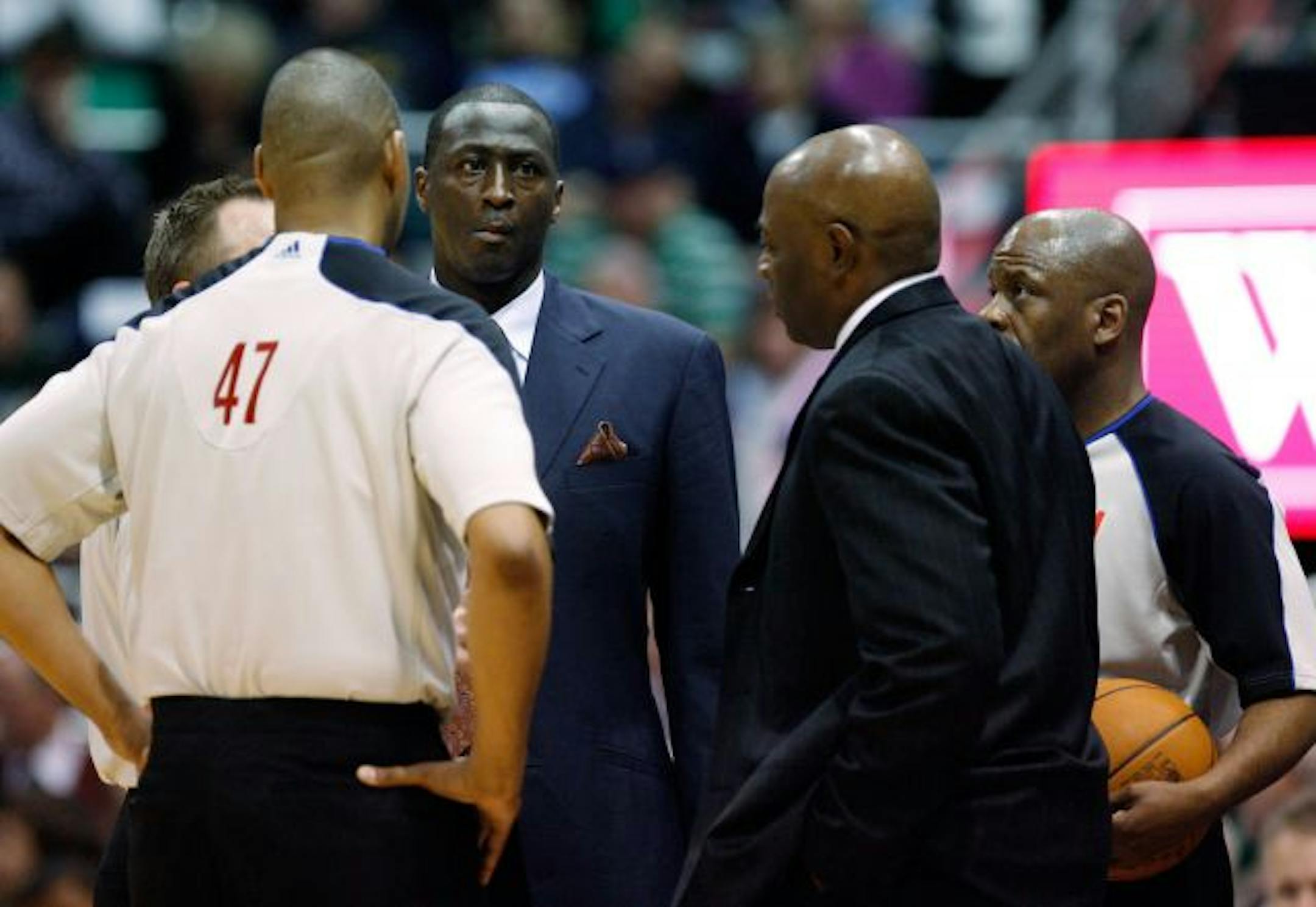 Utah Jazz coach Tyrone Corbin, center left, and Golden State Warriors coach Keith Smart, center right, meet with the officials to discuss a power problem during the first half of an NBA basketball game in Salt Lake City, Wednesday, Feb. 16, 2011.