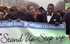 l to r Rev Dr. Al Sampson was the keynote speaker , Sen. Norm Coleman and Tyrone Terrill Human Rights Dir. St Paul march along Marshal Ave in the MLK 