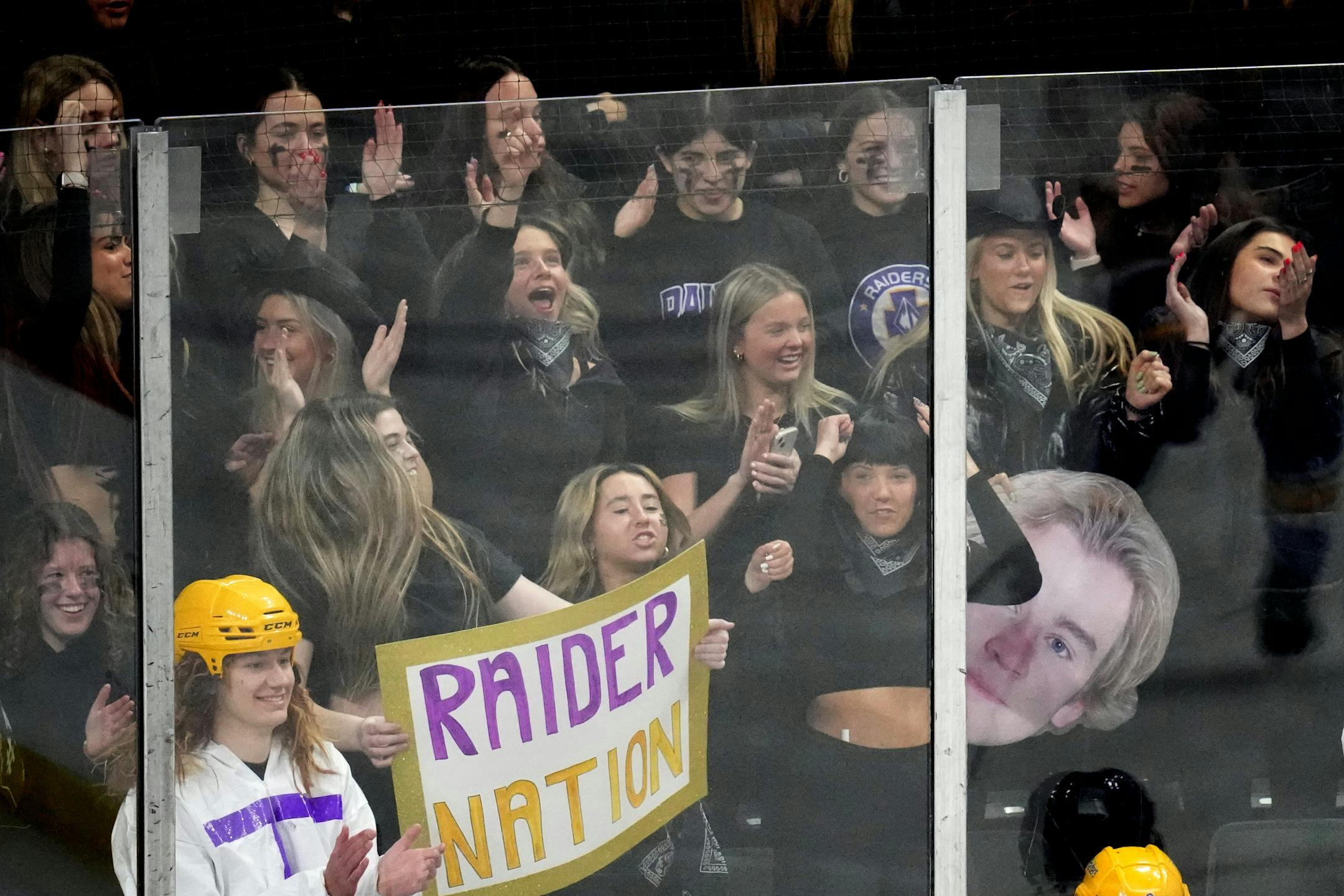 Cretin-Derham Hall fans cheered as their team took to the ice before the start of a MSHSL Class 2A quarterfinal hockey game between state tournament Cretin-Derham Hall and Maple Grove.