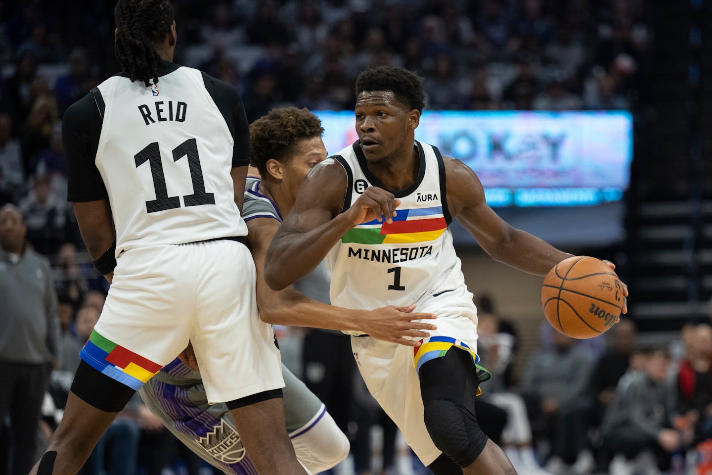 Minnesota Timberwolves guard Anthony Edwards (1) uses a screen set by teammate center Naz Reid (11) against Sacramento Kings forward Kessler Edwards, center, in the first quarter in an NBA basketball game in Sacramento, Calif., Monday, March 27, 2023. (AP Photo/José Luis Villegas)