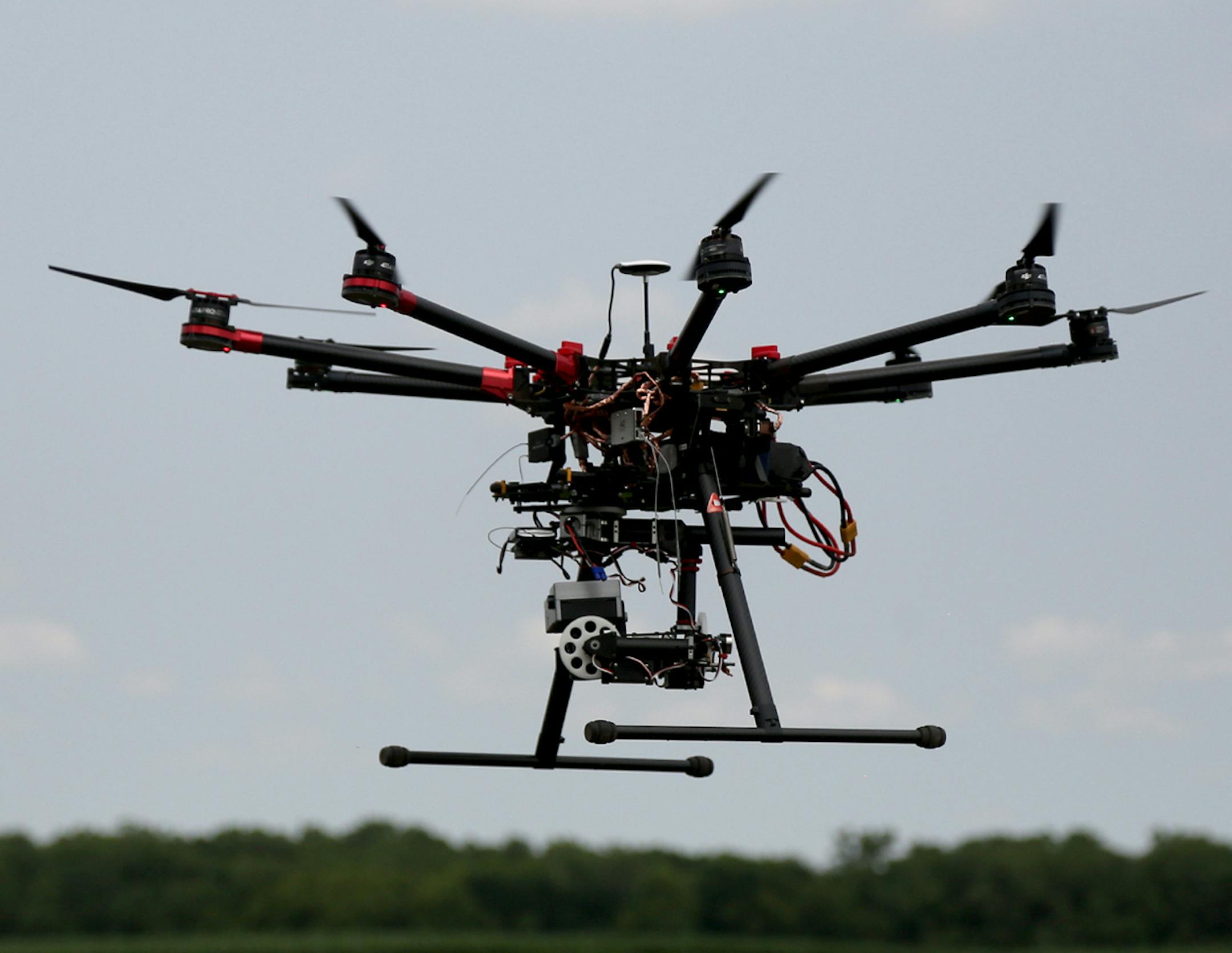 This DJIS-1000 hovered as to landed after a test flight. ] (KYNDELL HARKNESS/STAR TRIBUNE) kyndell.harkness@startribune.com University of Minnesota researchers are testing how well drones, or unmanned aircraft systems, detect insects like soybean aphids and potato beetles. in Rosemount, Min., Thursday, July 7, 2015. ORG XMIT: MIN1507071424400151