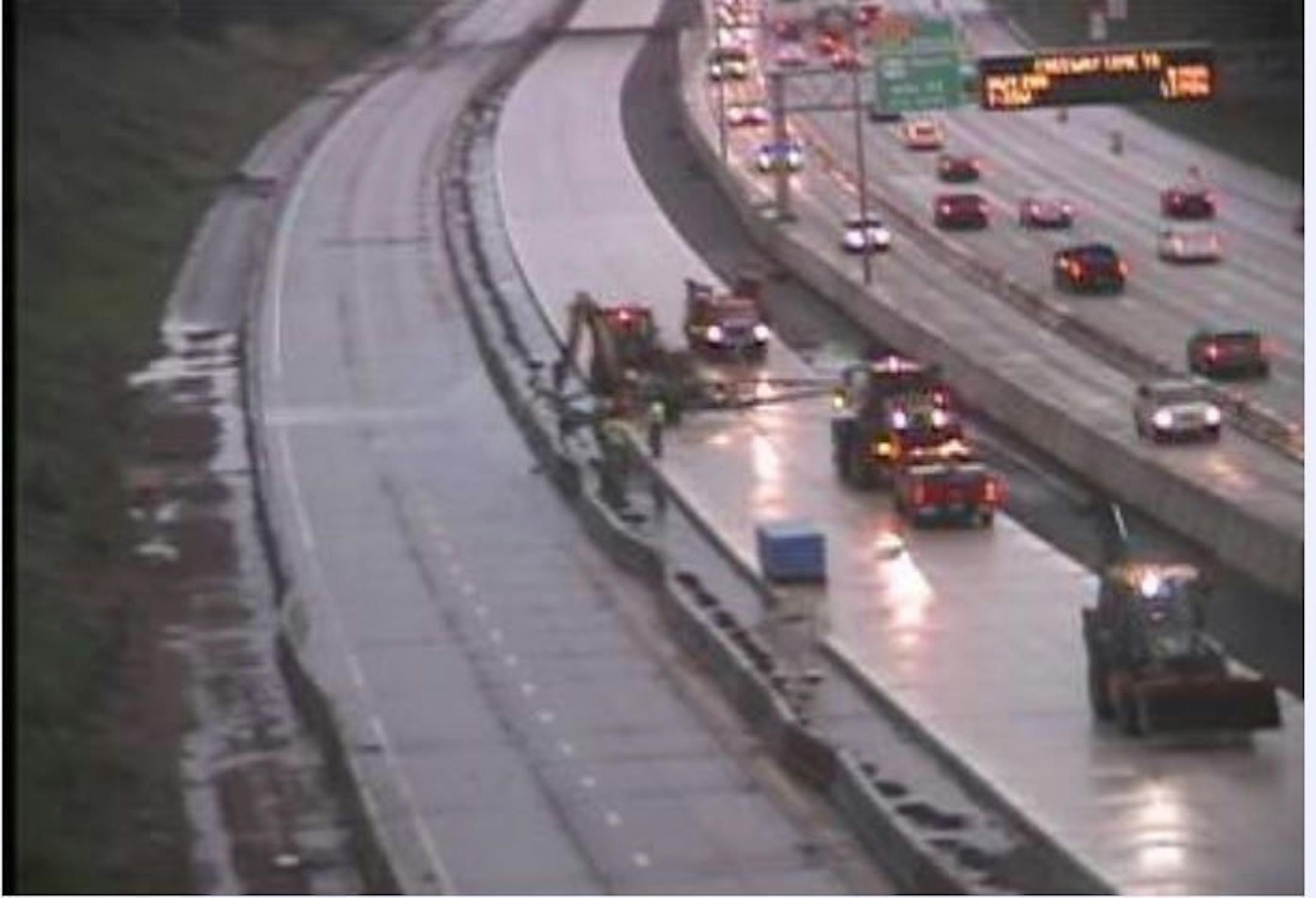 Contractors work to clear flooding on eastbound I-94 at Johnson Parkway in St. Paul.