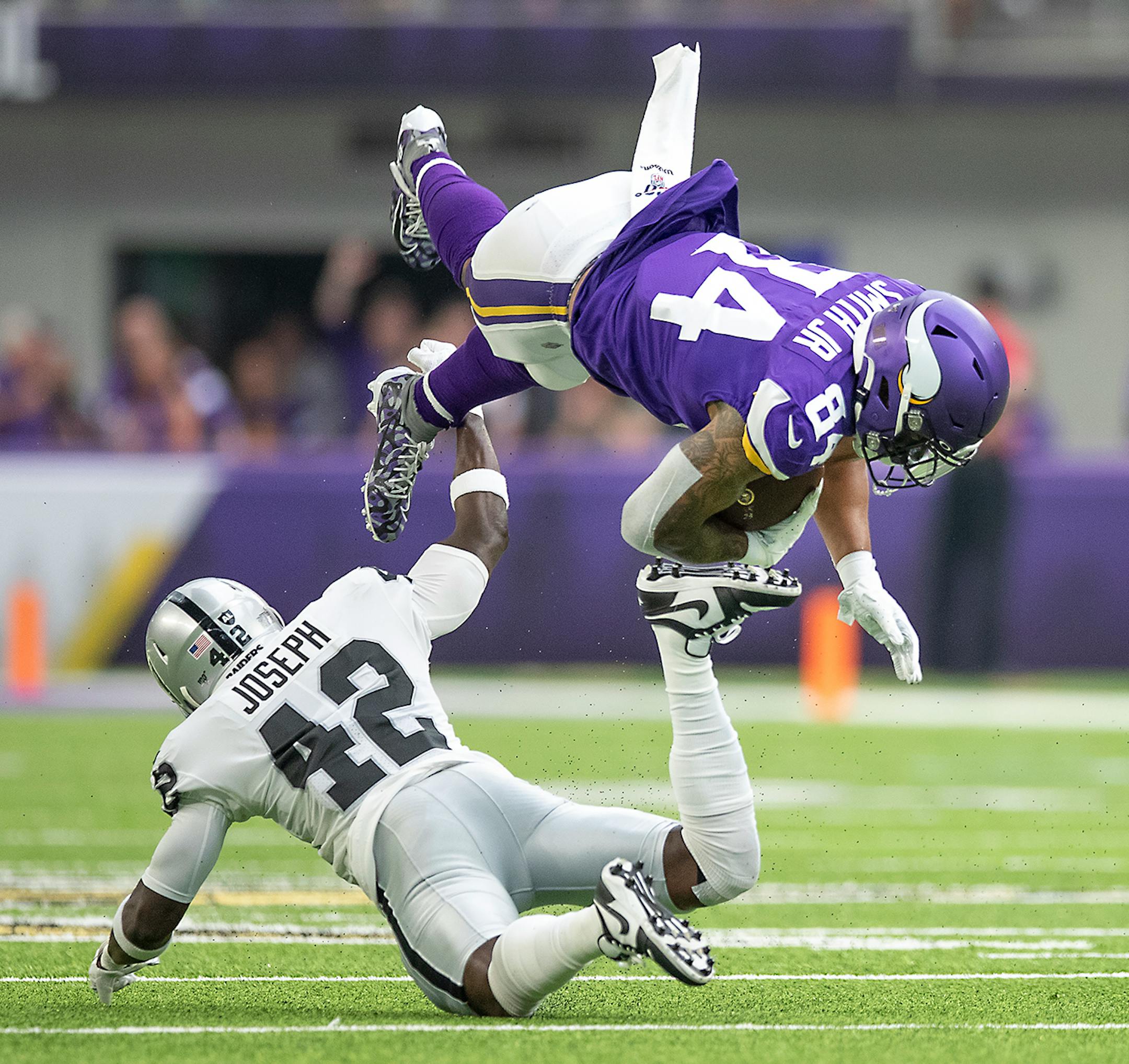 Vikings tight end Irv Smith run before being stopped by Raiders free safety Karl Joseph in first quarter.