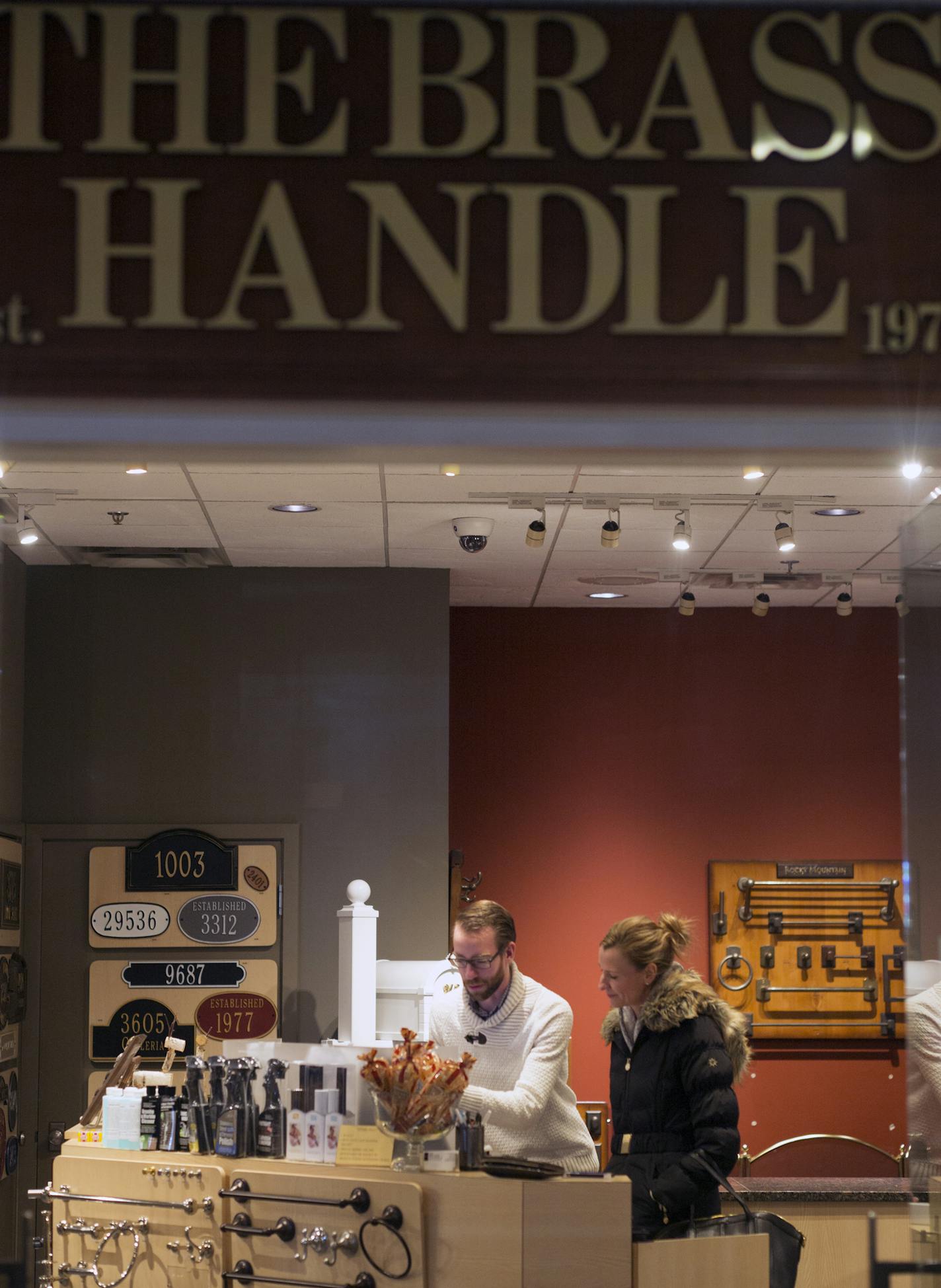 At "The Brass Handle" store at the Galeria which is moving out, Laura Carlson is doing a total renovation of the five bathrooms in her house in Edina. She got help from salesman Dan Undem.] Richard Tsong-Taatarii/rtsong-taatarii@startribune.com