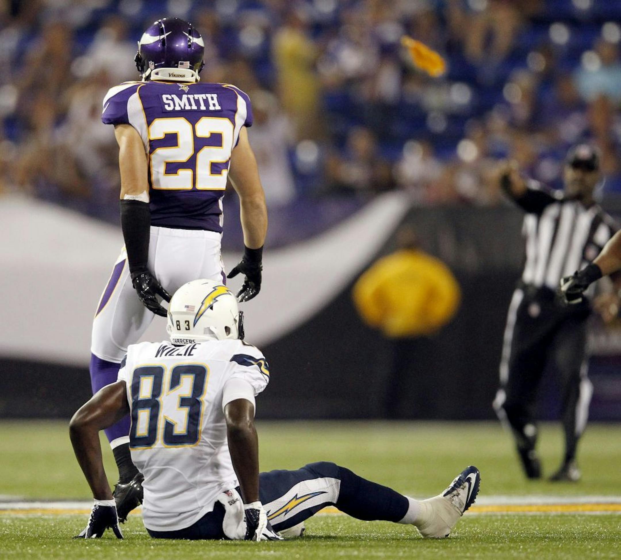A referee threw a flag after a hit by the Minnesota Vikings' Harrison Smith (22) on Mike Willie (83) late in the fourth quarter of San Diego's 12-10 win at Mall of America Field in NFL preseason action in Minneapolis, Minnesota, on Friday, August 24, 2012. Smith was called for a personal foul on the play.