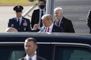 Supporters, including U.S. Representative Tom Emmer, behind Trump, meet President Donald Trump as he arrived at MSP airport Wednesday September 30.