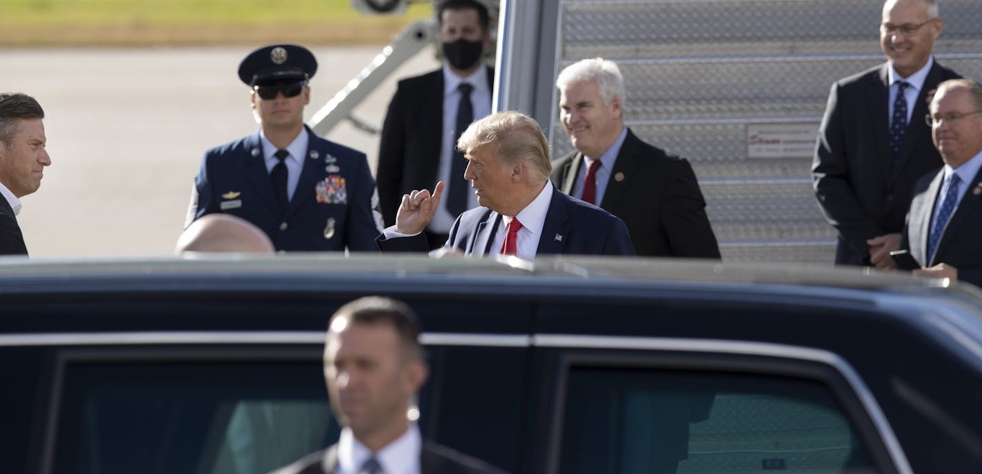 Supporters, including U.S. Representative Tom Emmer, behind Trump, meet President Donald Trump as he arrived at MSP airport Wednesday September 30.