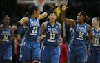 Minnesota Lynx forward Maya Moore (23) and forward Rebekkah Brunson (32) high fived over guard Seimone Augustus (33) as they headed to the bench for a