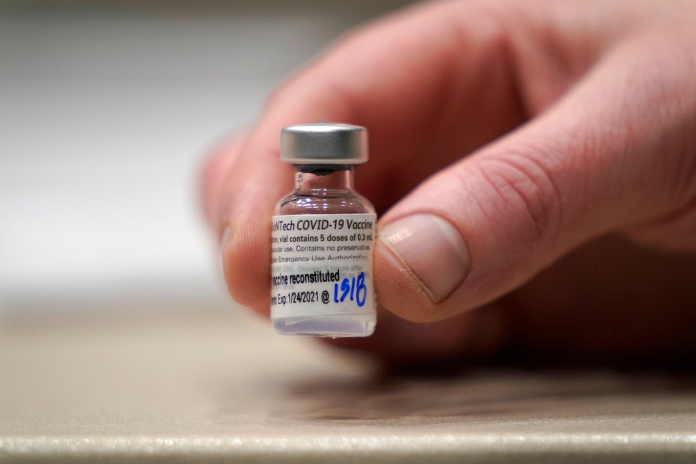 FILE - In this Jan. 24, 2021, file photo, a vial of the Pfizer vaccine for COVID-19 is shown at a one-day vaccination clinic set up in an Amazon.com facility in Seattle and operated by Virginia Mason Franciscan Health. Pfizer announced Wednesday, March 31, 2021 that its COVID-19 vaccine is safe and strongly protective in kids as young as 12, a step toward possibly beginning shots in this age group before they head back to school in the fall. (AP Photo/Ted S. Warren, File)