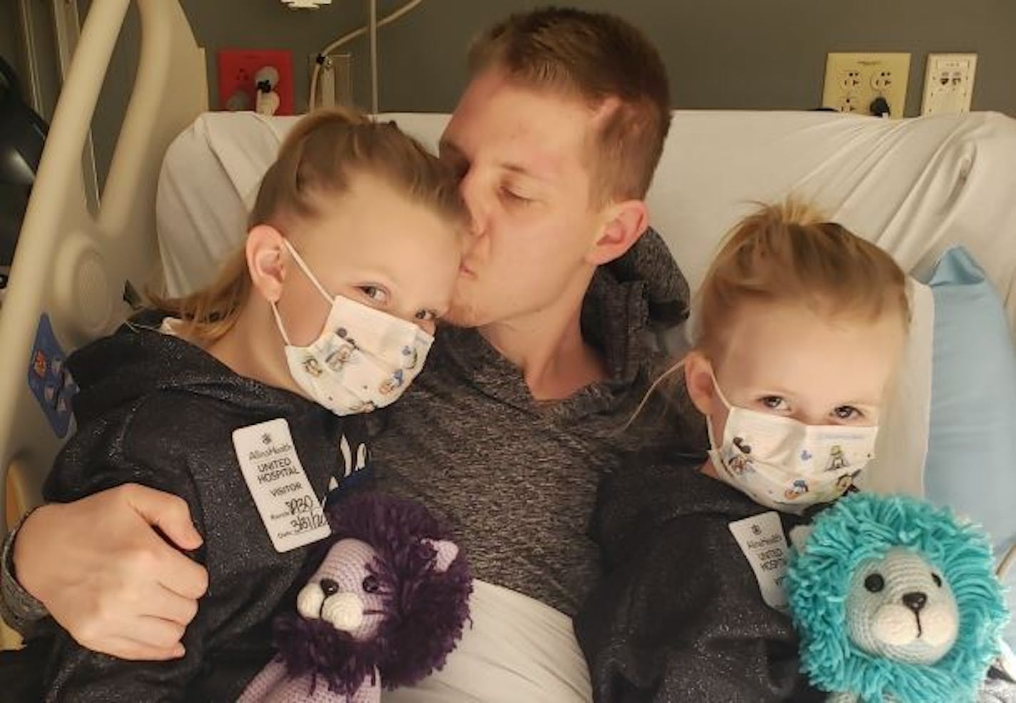 Arik Matson and his daughters Audrina, 7, left, and Maklynn, 5, at United Hospital in St. Paul late last month, shortly before he was moved to a different facility.