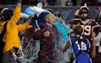 Minnesota head coach P.J. Fleck reacts after being doused during at the end of the team's Guaranteed Rate Bowl NCAA college football game against West
