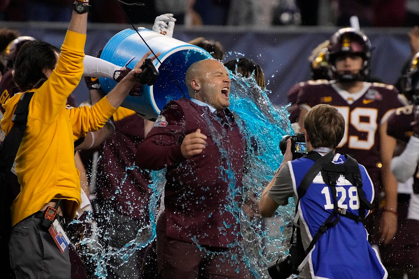 Minnesota head coach P.J. Fleck reacts after being doused during at the end of the team's Guaranteed Rate Bowl NCAA college football game against West Virginia on Tuesday, Dec. 28, 2021, in Phoenix. Minnesota won 18-6. (AP Photo/Rick Scuteri)