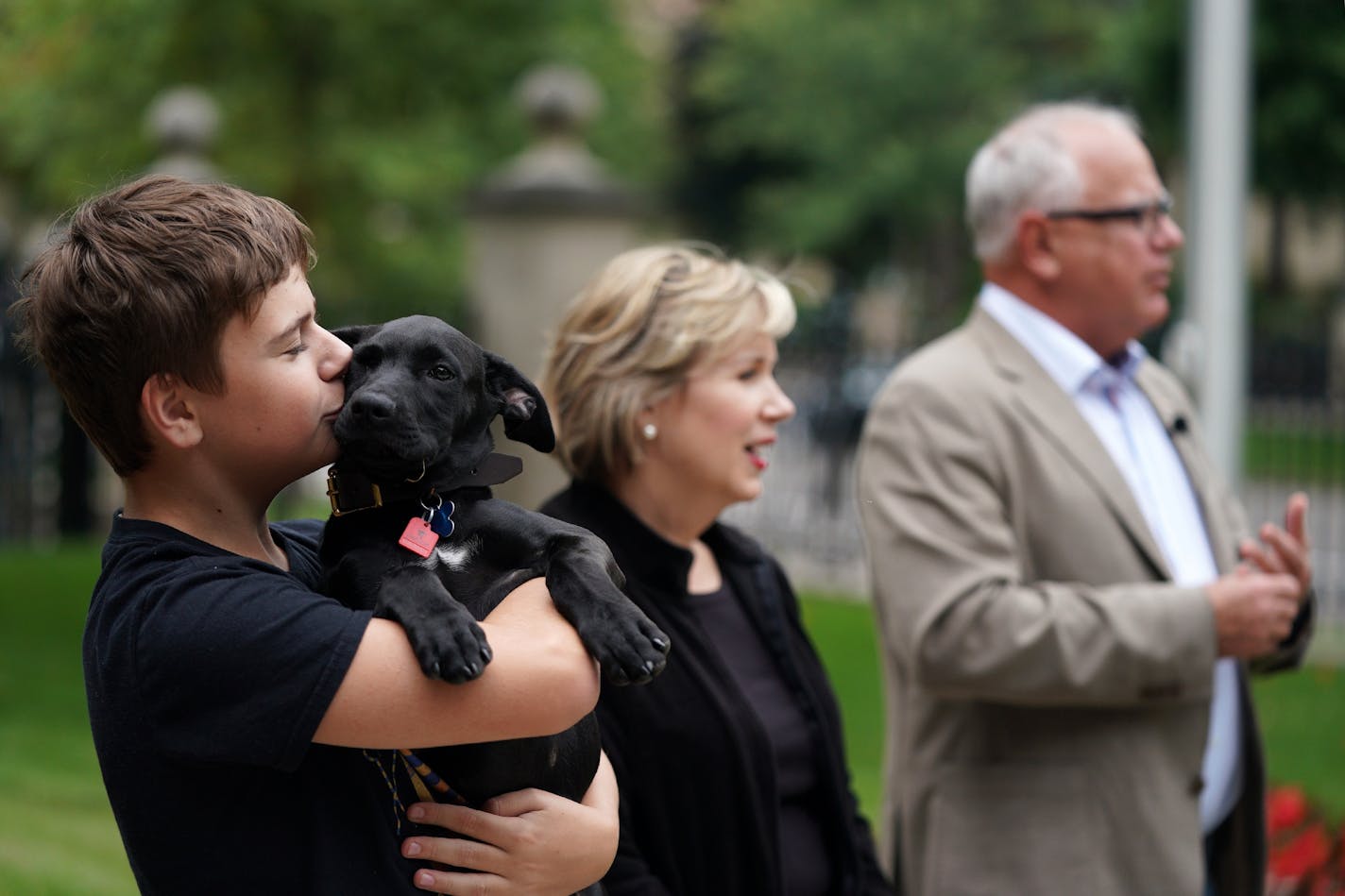 Gus Walz held Scout, a 3-month-old Labrador Retriever the Walz family adopted, during a press conference to announce the family's newest addition at the residence Thursday afternoon.