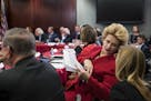 Sen. Debbie Stabenow, D-Mich., a member of the Senate Finance Committee, confers with an aide as tax bill conferees gather to work on the sweeping GOP