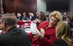 Sen. Debbie Stabenow, D-Mich., a member of the Senate Finance Committee, confers with an aide as tax bill conferees gather to work on the sweeping GOP