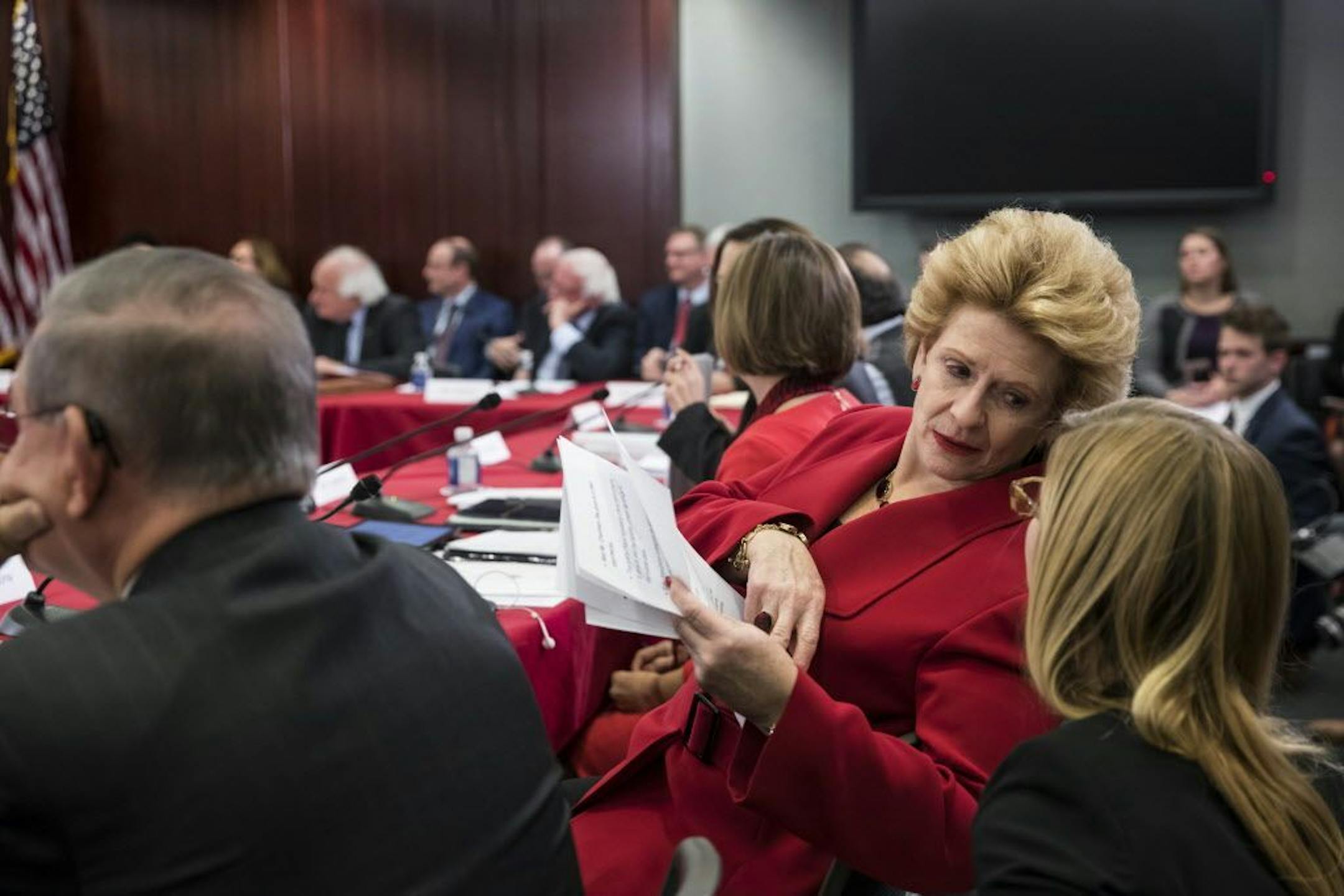 Sen. Debbie Stabenow, D-Mich., a member of the Senate Finance Committee, confers with an aide as tax bill conferees gather to work on the sweeping GOP plan, on Capitol Hill in Washington, Wednesday, Dec. 13, 2017.
