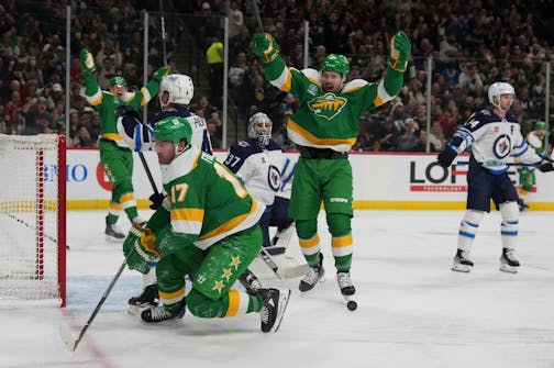 Minnesota Wild right wing Brandon Duhaime (21) celebrates Minnesota Wild left wing Marcus Foligno's (17) goal in the second period. The Minnesota Wild hosted the Winnipeg Jets on Wednesday, Nov. 23, 2022 at the Xcel Entry Center in St. Paul, Minn.