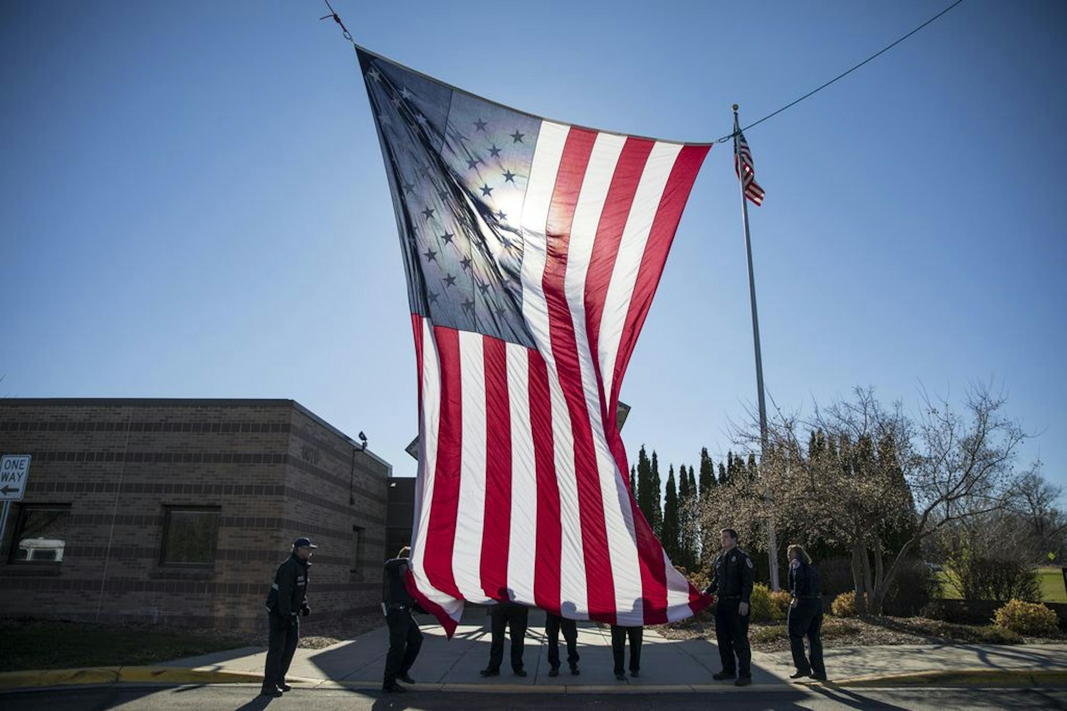 Inver Grove Heights fire fighters lowered a giant American flag at the Inver Grove Heights Veterans Memorial Community Center on Friday, November 11, 2016.