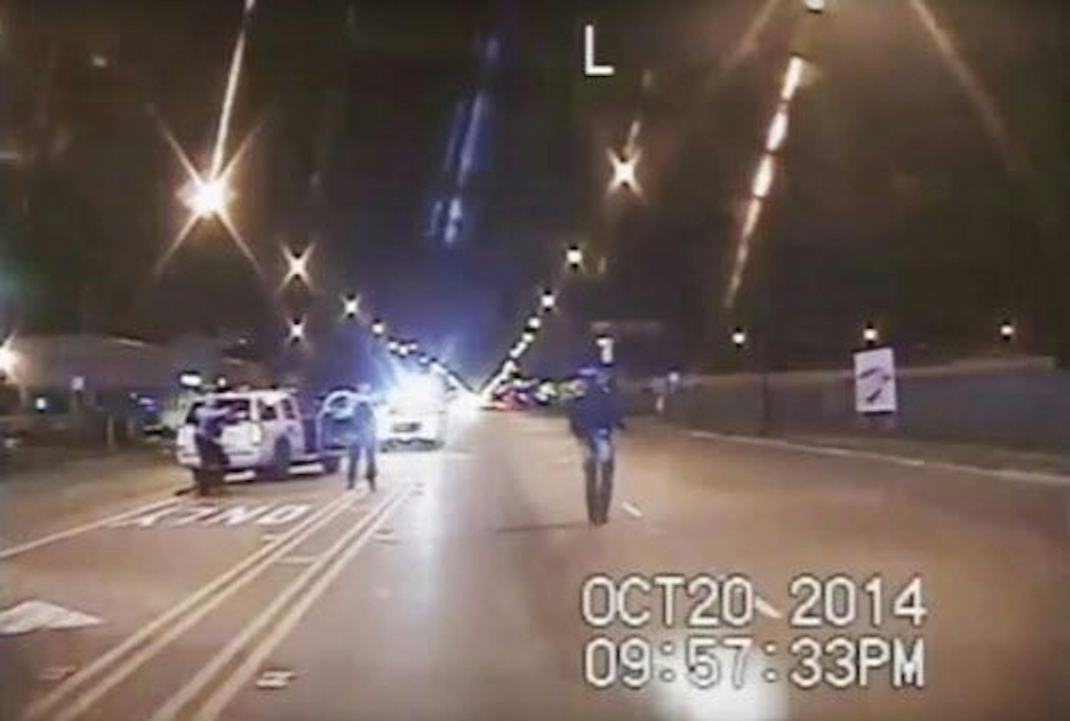 FILE - In this Oct. 20, 2014 frame from dash-cam video provided by the Chicago Police Department, Laquan McDonald, right, walks down the street moments before being fatally shot by CPD officer Jason Van Dyke sixteen times in Chicago.