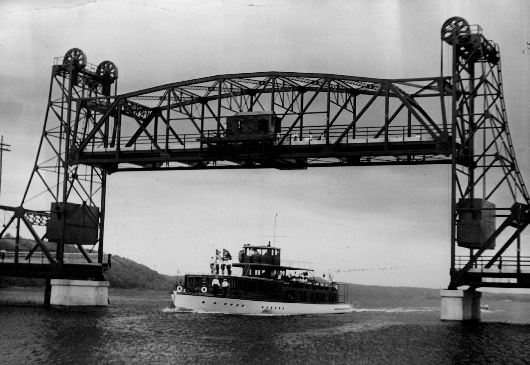 July 2, 1931 Anchors were aweigh yesterday as the Mayo yacht, North Star, passed under the lift span of the new interstate bridge over the St. Croix river at Stillwater, symbolizing river traffic of the city. The yacht was the first vessel to pass through the span and played a prominent part in the ceremonies. Below, Governor Floyd B. Olson of Minnesota and Adjutant General Ralph Immel of Wisconsin are seen breaking the ribbon stretched at the interstate line, officially opening the bridge. Minn