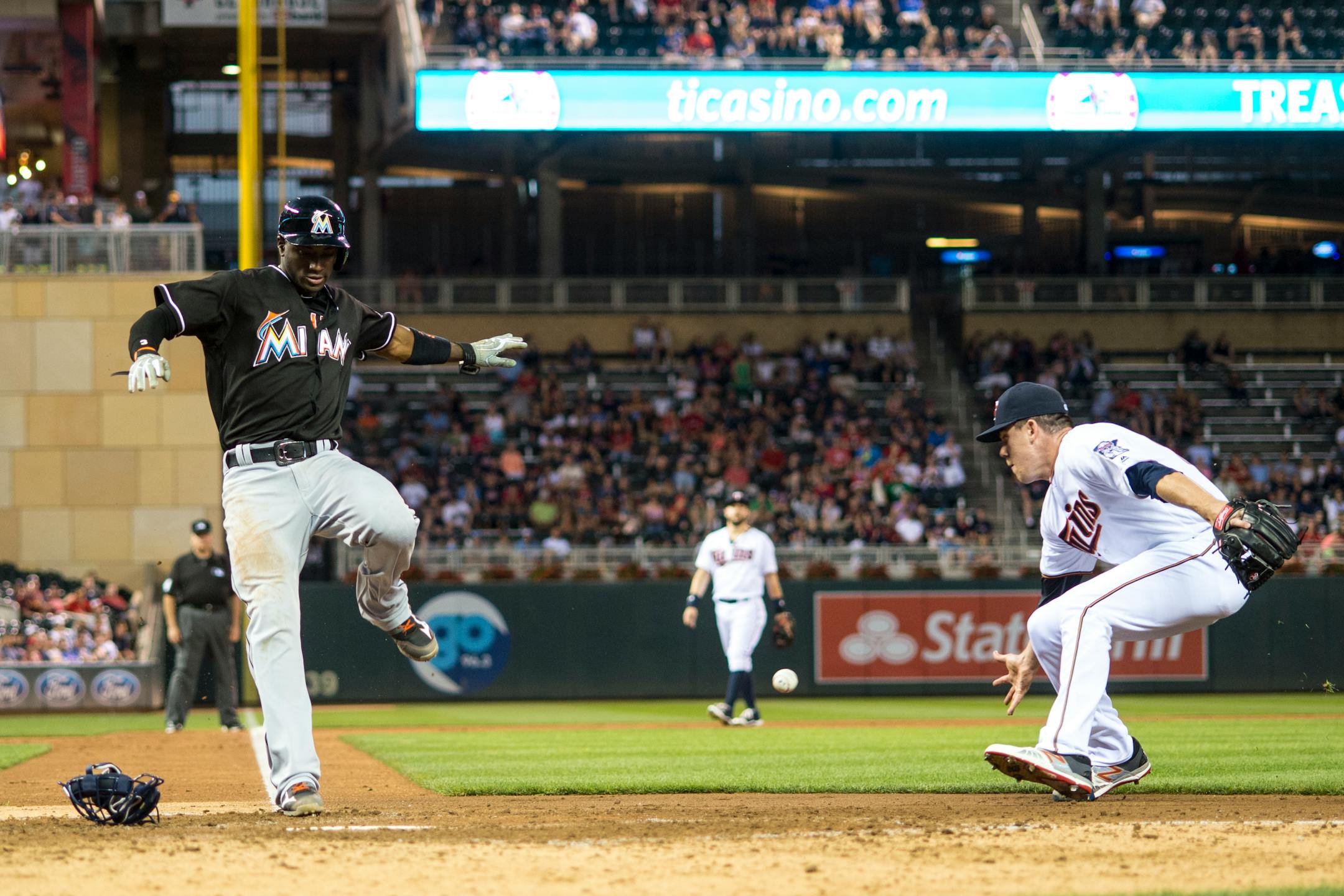Miami Marlins shortstop Adeiny Hechavarria (3) scored after a wild pitch by Minnesota Twins relief pitcher Trevor May (65) in the top of the 7th inning Thursday.