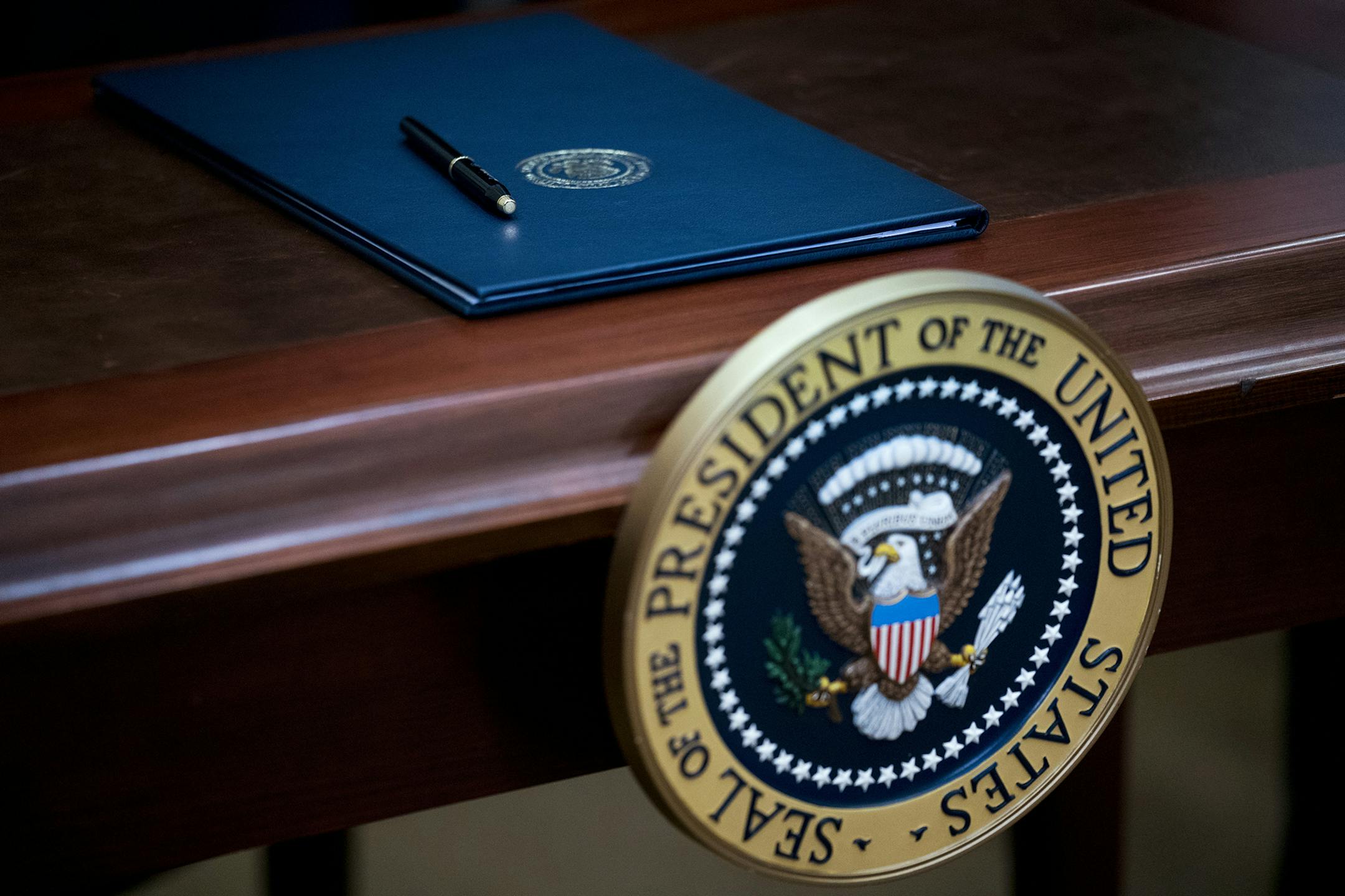 A desk with the presidential seal and an executive order for the "Apprenticeship and Workforce of Tomorrow" program, during a signing event with President Donald Trump in the Roosevelt Room of the White House, in Washington, June 15, 2017. Trump's action aims to expand federally funded apprenticeship programs. (Doug Mills/The New York Times) ORG XMIT: MIN2017072512244438 ORG XMIT: MIN1707251228435793