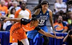 Connecticut Sun's Alex Bentley, left, reaches for a loose ball against Minnesota Lynx's Seimone Augustus, right, during the first half of a WNBA baske