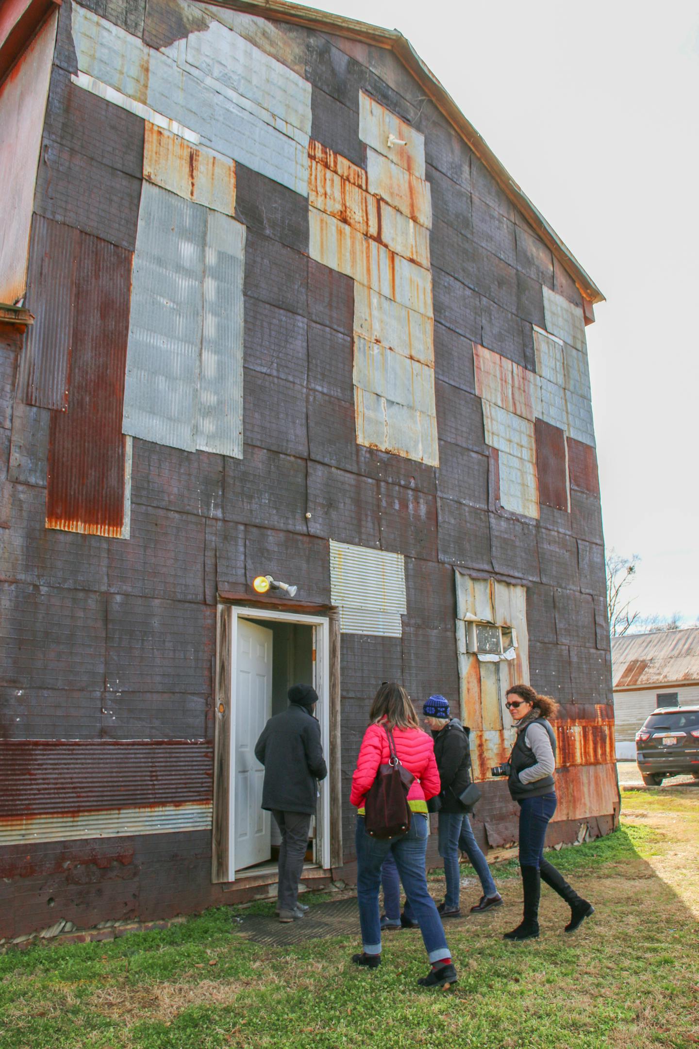 Caleb Munson leads visitors into the Red Barn, the studio of Auburn University's Rural Studio in Newbern, Ala. Photo by Jillian Banner, special to the Star Tribune