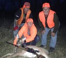 On a recent Missouri deer hunt, Star Tribune reporter Abby Simons, center, and the doe she shot are flanked by Simons' friend Phil Replogle, left, and