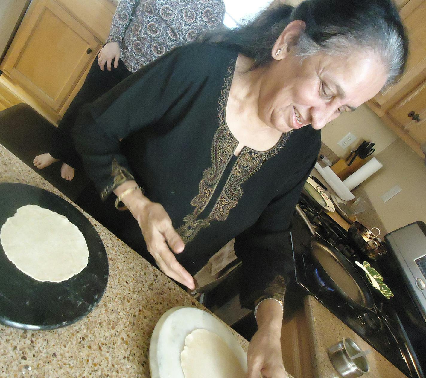 Ila Patel shapes the roti, a traditional Indian flatbread.