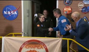 The crew members of the first CHAPEA mission, Kelly Haston, center, shakes hands with NASA Deputy Director Flight Missions Kjell Lindgren, second righ