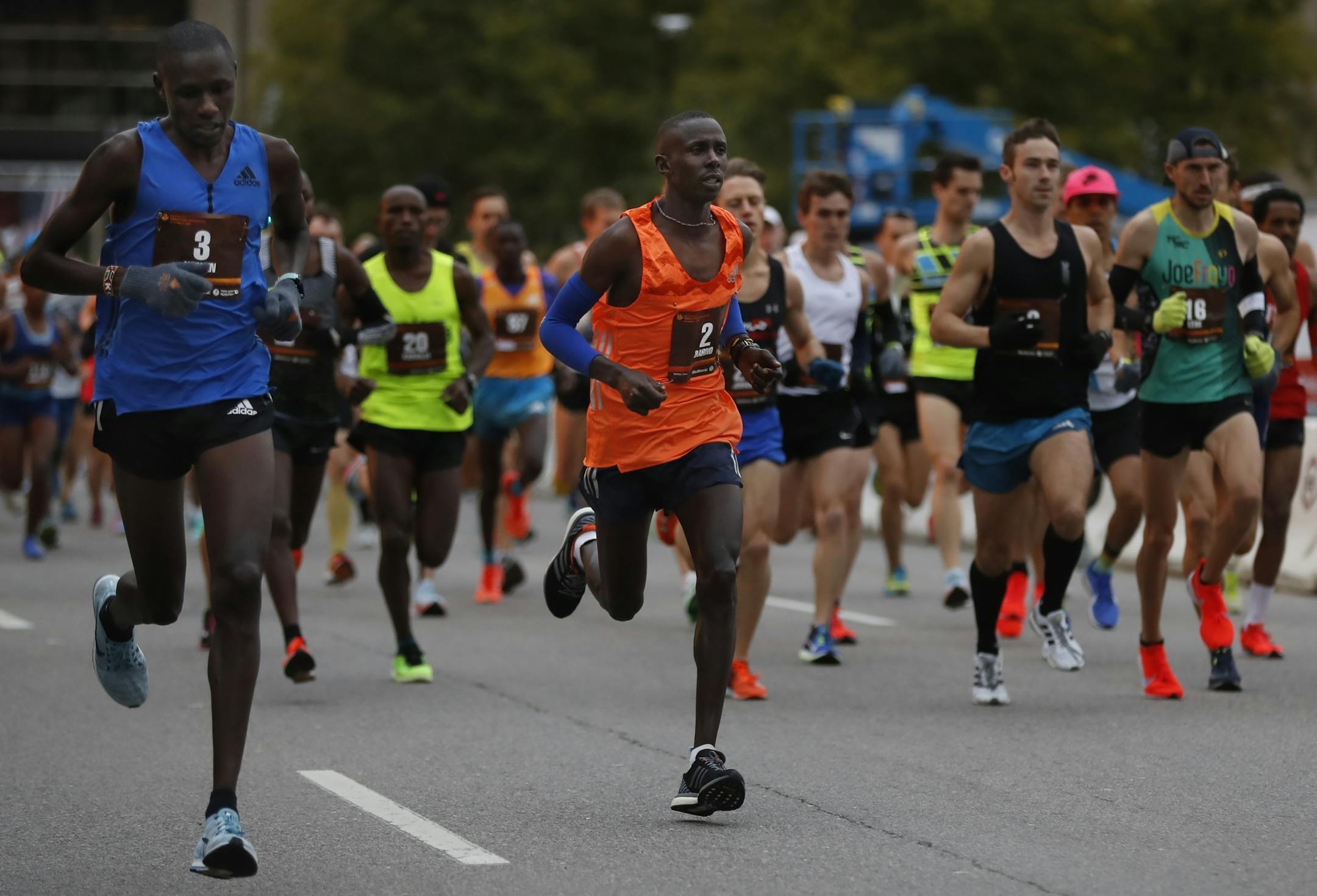 Boniface Kongin(3) and eventual winner Elisha Barno(2) got out near the front for the start of the marathon.