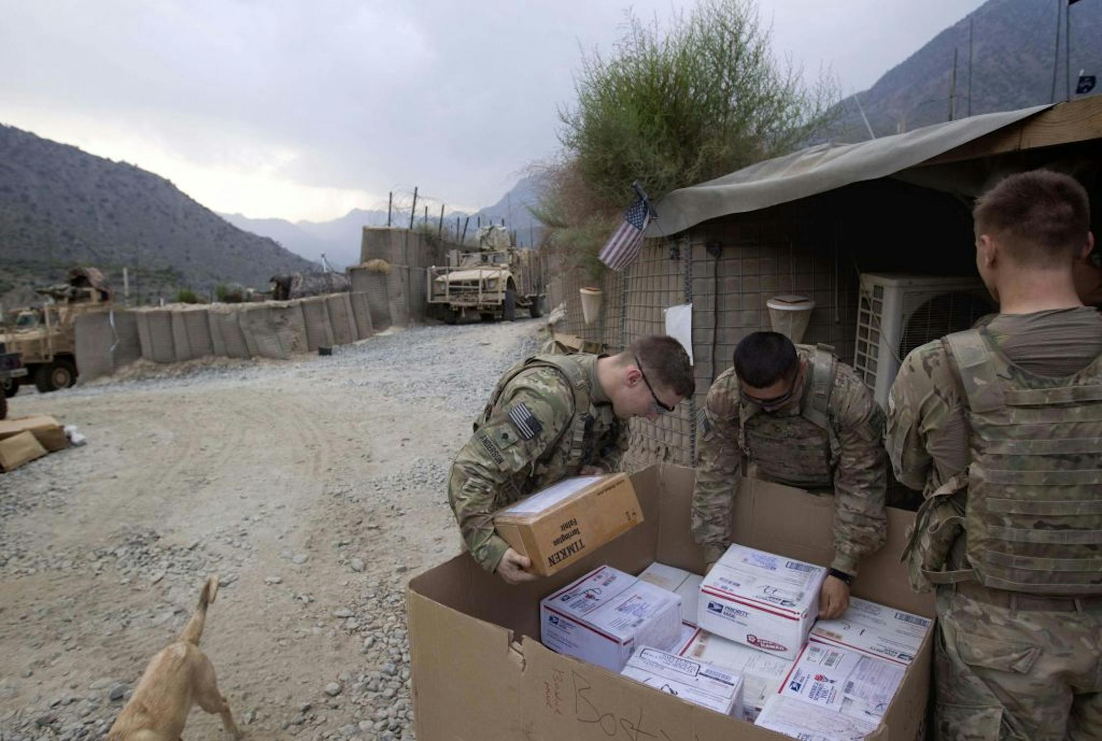 Specialist Michael Anderson, 26, left, of Black River Falls, Wis., and Pfc. Martin Cervantes, 20, of Orange County, Calif., both with the U.S. Army's 2nd Battalion, 27th Infantry Regiment, based in Hawaii, looked through a mail delivery Thursday. They are stationed at Combat Outpost Pirtle King in Kunar Province, Afghanistan, near the border with Pakistan.