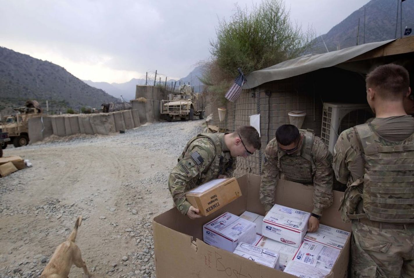 Specialist Michael Anderson, 26, left, of Black River Falls, Wis., and Pfc. Martin Cervantes, 20, of Orange County, Calif., both with the U.S. Army's 2nd Battalion, 27th Infantry Regiment, based in Hawaii, looked through a mail delivery Thursday. They are stationed at Combat Outpost Pirtle King in Kunar Province, Afghanistan, near the border with Pakistan.