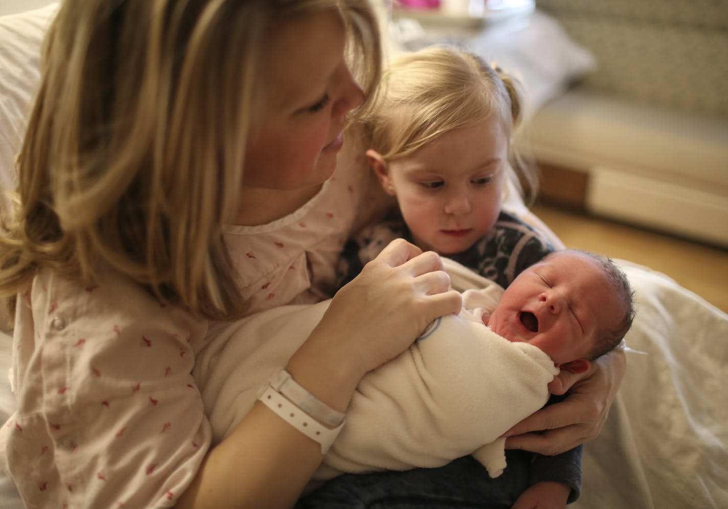 Mila Warner held her newborn brother, Cash, for the first time in her mother, Brianna's lap a few hours after he was born Monday. He'll have four other sisters to contend with as he grows up. ] JEFF WHEELER &#xef; jeff.wheeler@startribune.com Brianna Warner and her husband, Willard Jedlicka, scheduled the c-section birth of their son, Cash Willard Warner, for Leap Day. The boy was entered the world Monday, February 29, 2016 at Methodist Hospital in St. Louis Park. He'll grow up with his five sis