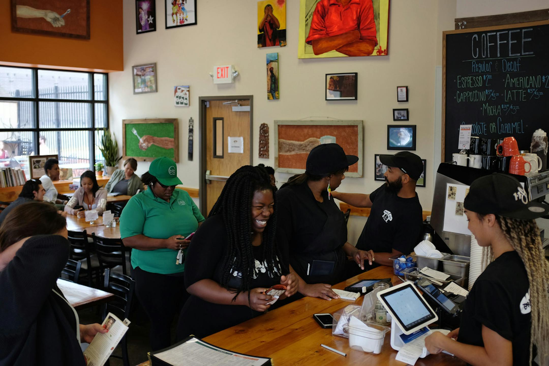Customers placed their orders at Breaking Bread Cafe Thursday afternoon. ] ANTHONY SOUFFLE • anthony.souffle@startribune.com Scenes from West Broadway Thursday, July 13, 2017 in north Minneapolis. For years, West Broadway has struggled to attract much commercial investment beyond fast food joints and convenience stores. It's been anchored by nonprofits and small businesses including nonprofit Juxtaposition Arts, Shiloh Temple, Sammy's Avenue Eatery and Breaking Bread Cafe. Local leaders a