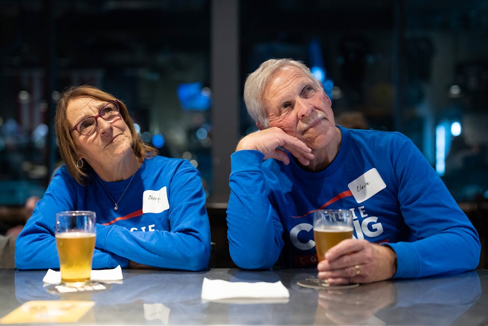 Cheryl Kortuem and Claire Hovland, left to right, watch election night coverage on television during a watch party for incumbent U.S. Rep. Angie Craig at Bald Man Brewing in Eagan, Minn. on Tuesday.