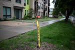 Police tape hangs from a tree near the site of a shooting May 31 on the 2200 block of Blaisdell Avenue S. in Minneapolis.