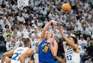 Nuggets center Nikola Jokic passes the ball over Timberwolves center Karl-Anthony Towns during the first quarter of Game 3 Friday night. Jokic finishe