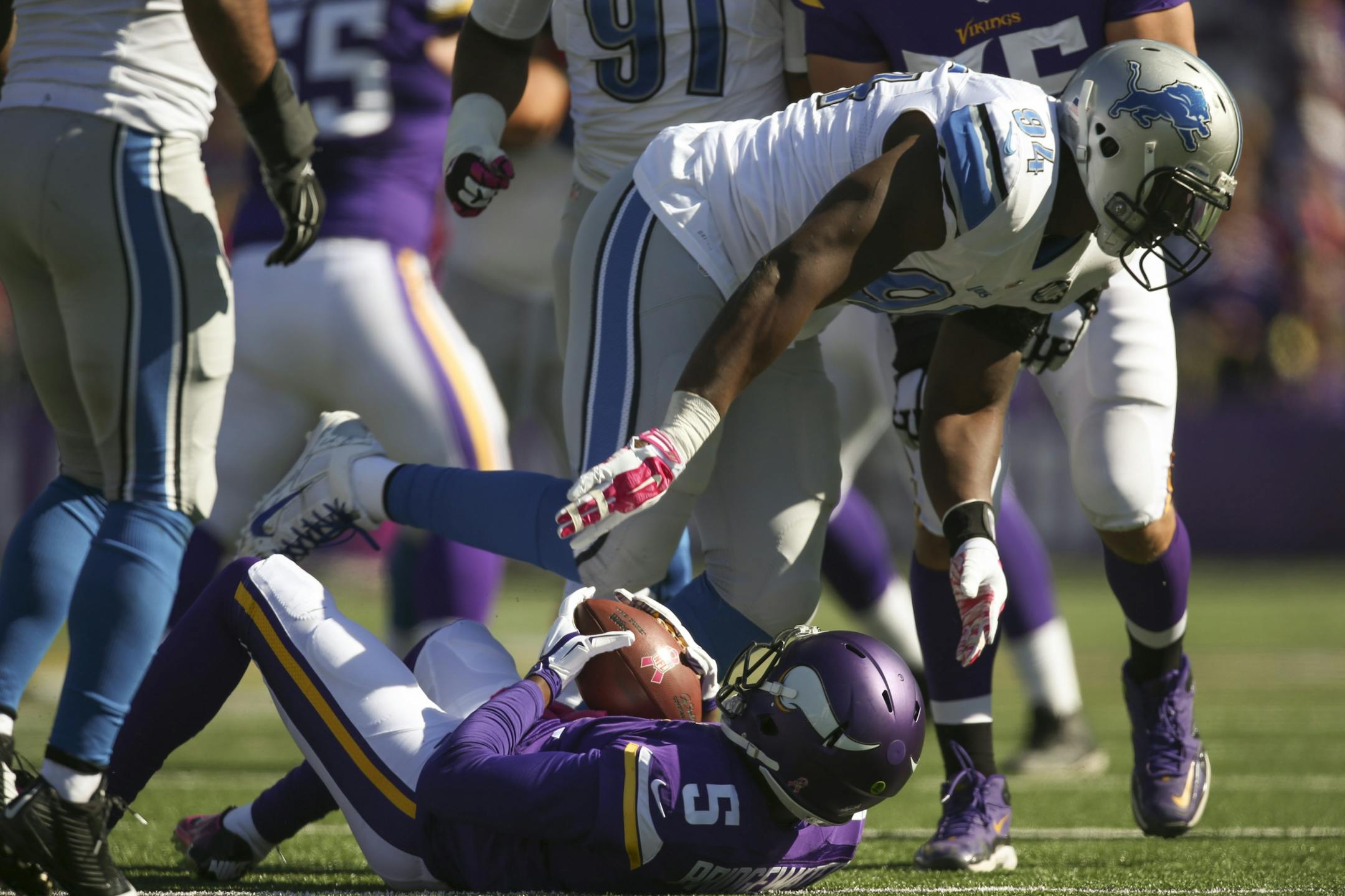Minnesota Vikings quarterback Teddy Bridgewater (5) was sacked for a ten yard loss by Detroit Lions defensive end Ezekiel Ansah (94) in the second quarter Sunday afternoon.
