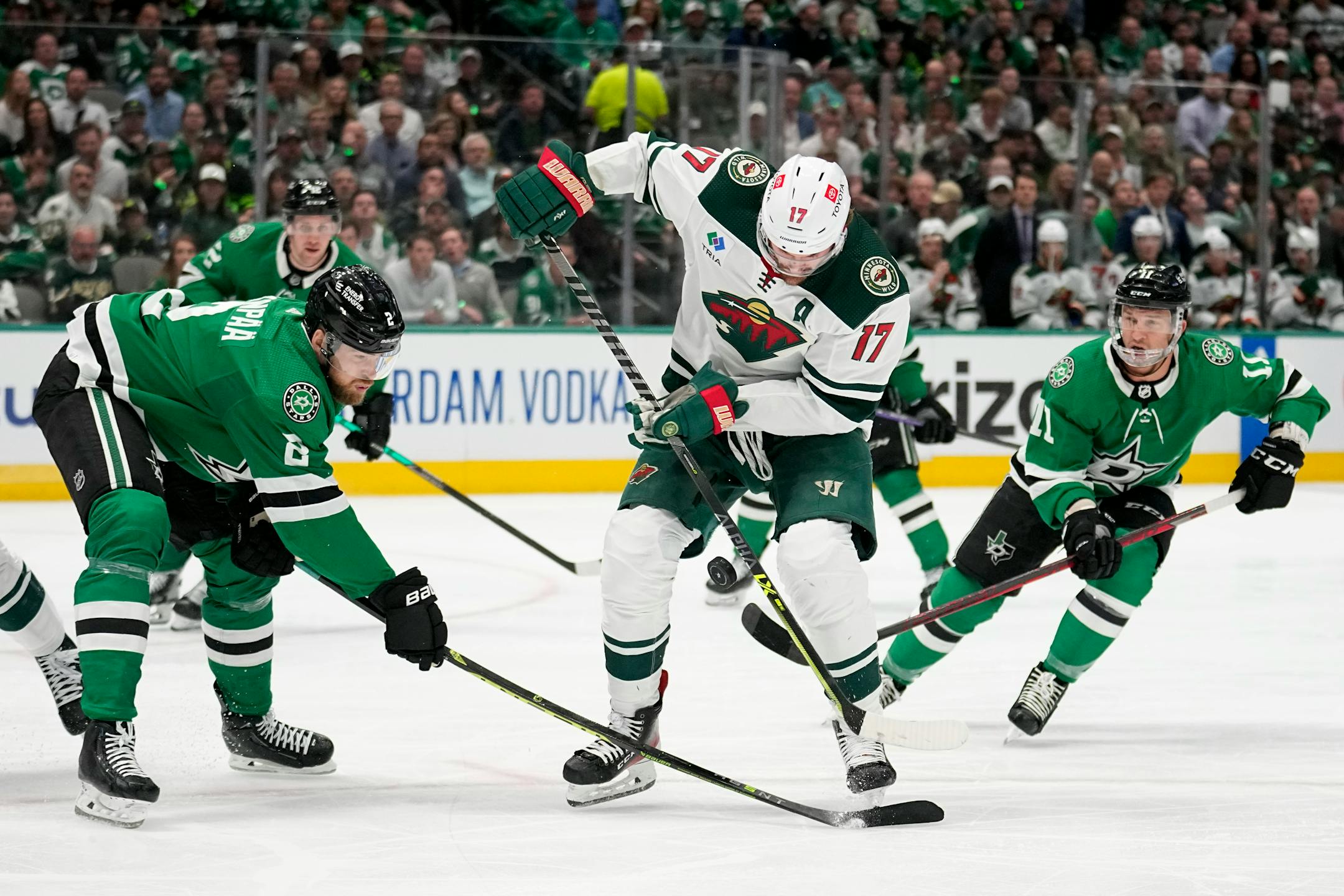 Minnesota Wild left wing Marcus Foligno (17) works against Dallas Stars defenseman Jani Hakanpaa (2) and Luke Glendening (11) for control of the puck in the second period of Game 2.