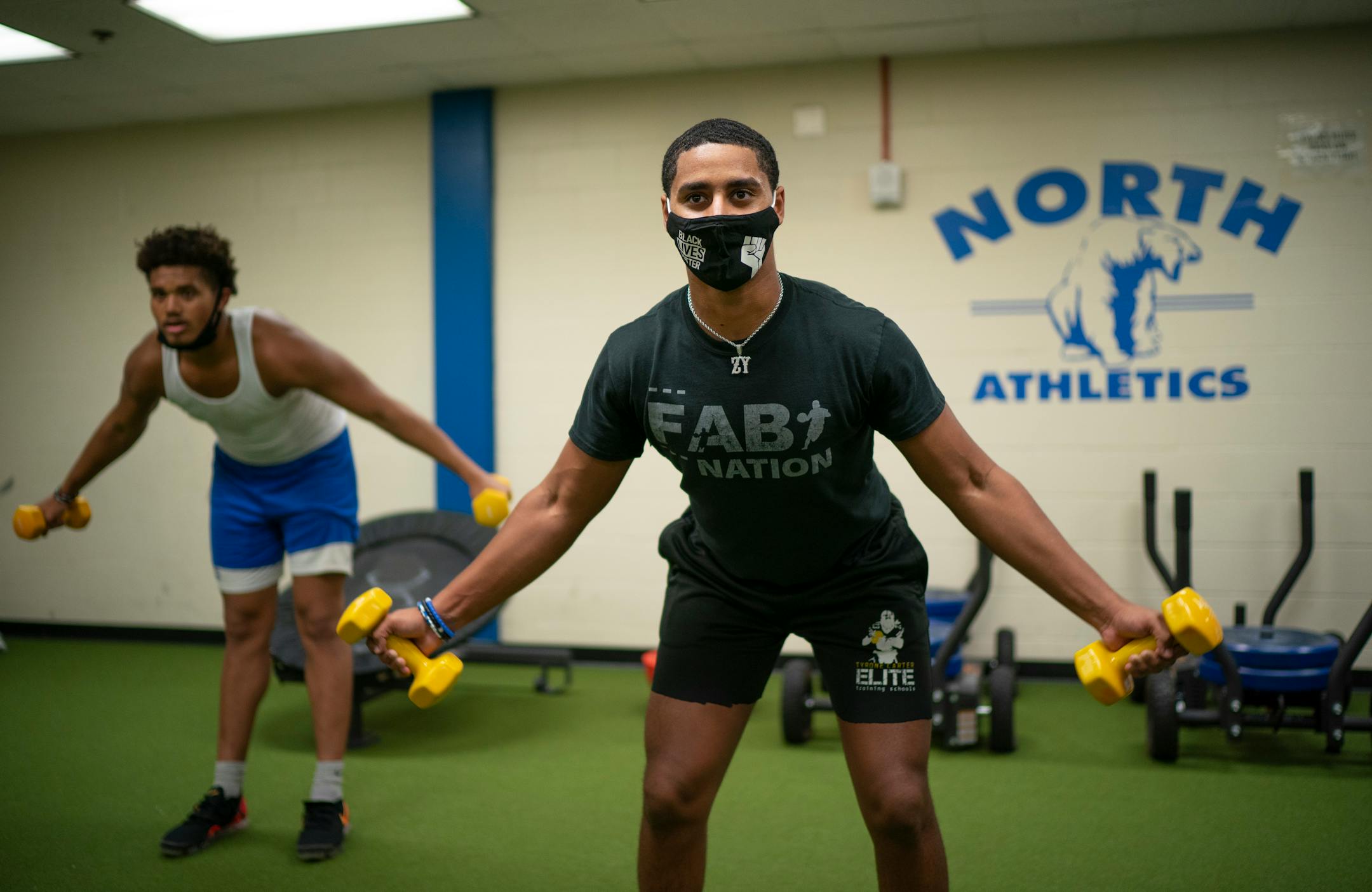 North High quarterback Zach Yeager lifted with defensive end Davon Townley on Monday afternoon.