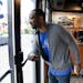 BP 36 Lyn Refuel Station owner Lonnie McQuirter used his forearm to open the door as he headed out do disinfect the gas pumps as a precaution against 