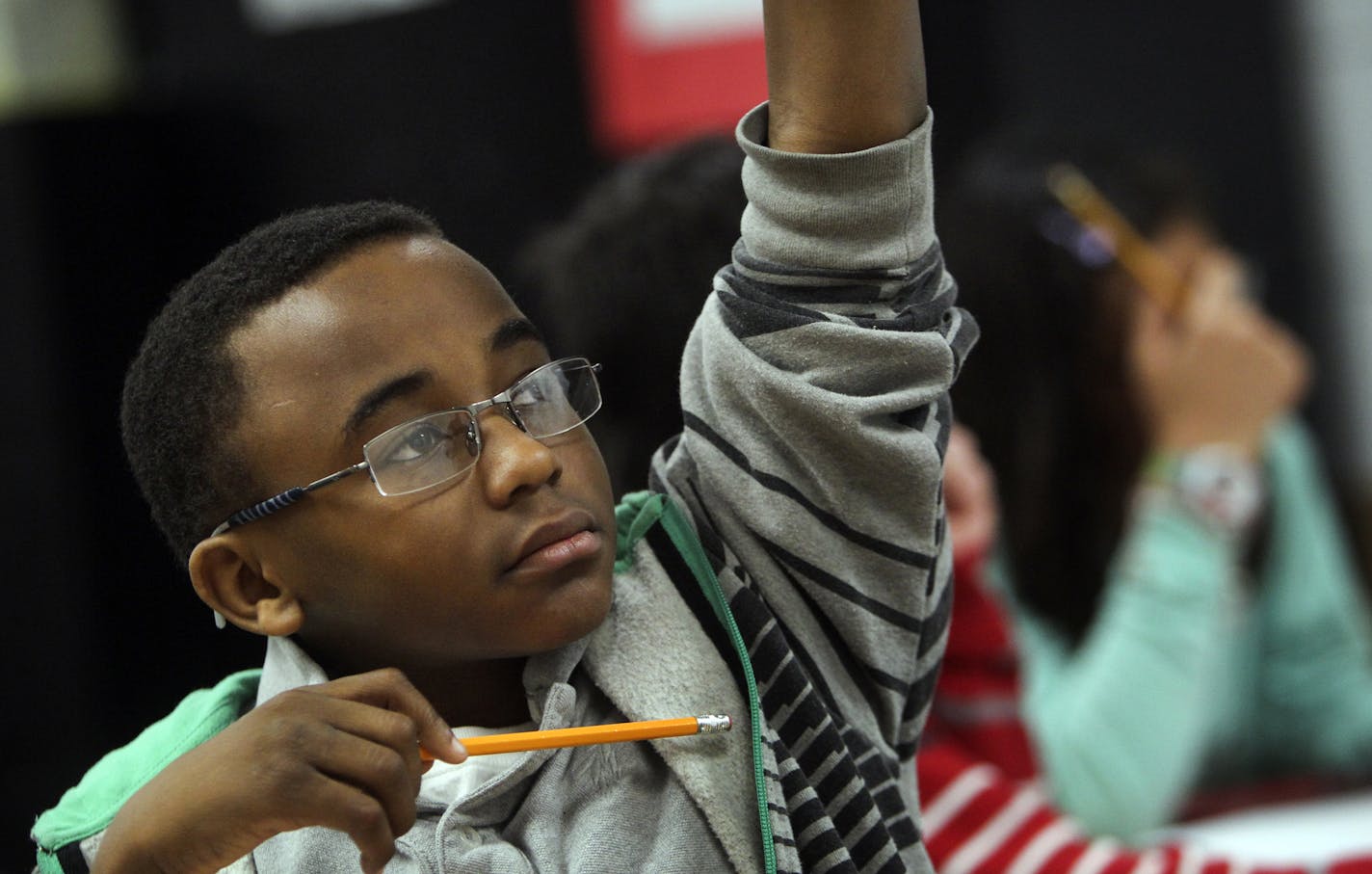 Fifth grader Jeremiah Jones raises his hand to answer a question during math class on an in-class assignment using iPads and an app called Socrative to test students and get immediate feedback on how they are doing Wednesday, Feb. 27, 2013, in Burnsville, MN.] (DAVID JOLES/STARTRIBUNE) djoles@startribune.com There is too much racial diversity at Sky Oaks Elementary in Burnsville and the school district has to come up with a plan to change the concentration of non-white students at the school Wed