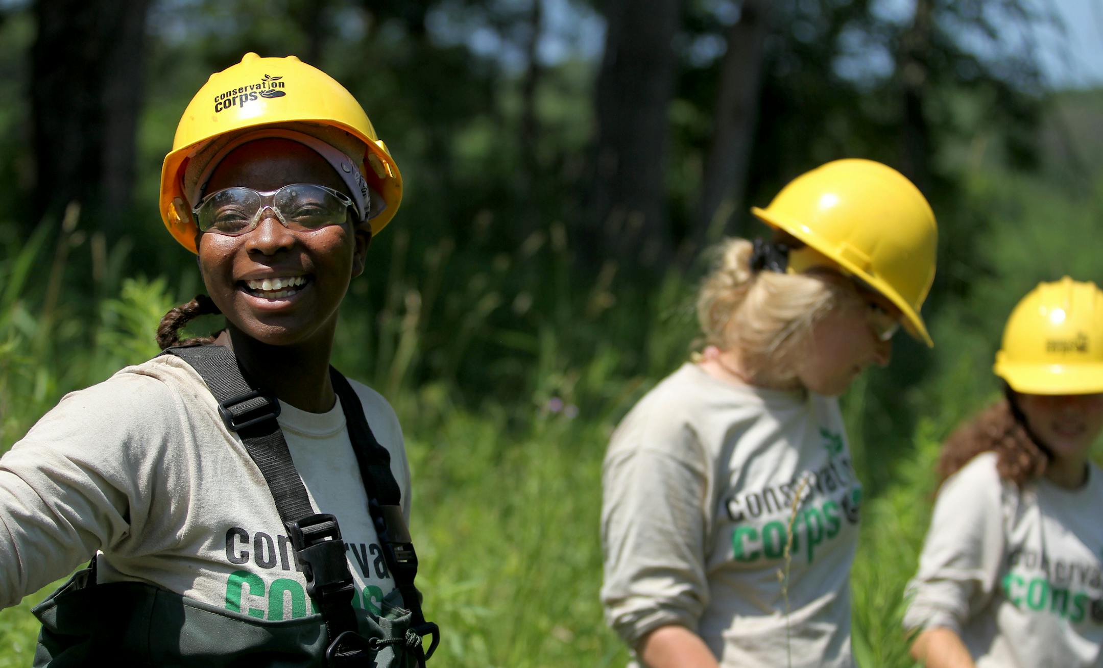 From left, Brianna Thompson, Jenny Carlenberg, and Zoe Webb work as a part of the Summer Youth Program of the Conservation Corps of Minnesota at the William O'Brien State Park, on Wednesday, July 10, 2013